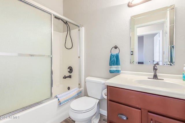 full bathroom featuring vanity, combined bath / shower with glass door, toilet, and hardwood / wood-style flooring