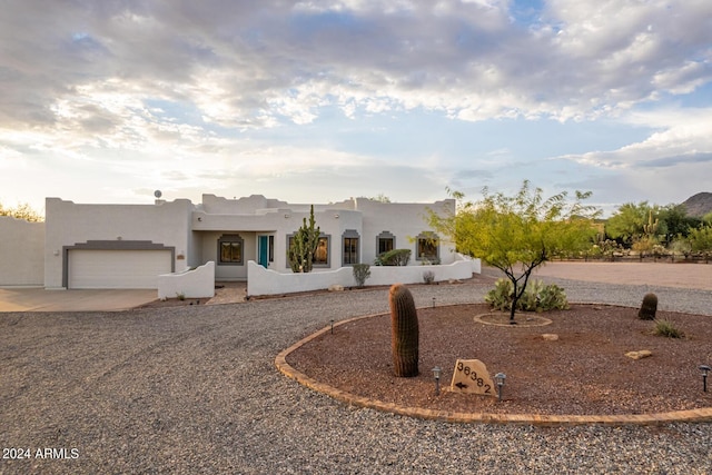 36382 N 35th St, Cave Creek, AZ 85331 - pueblo-style home featuring an attached garage, concrete driveway, and stucco siding