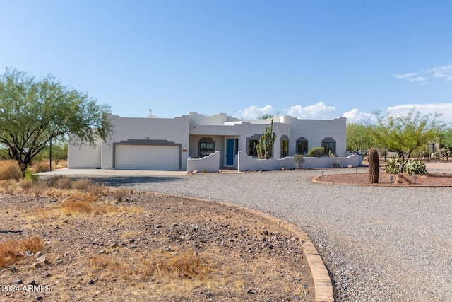 36382 N 35th St, Cave Creek, AZ 85331 - pueblo-style house featuring stucco siding, gravel driveway, and a garage