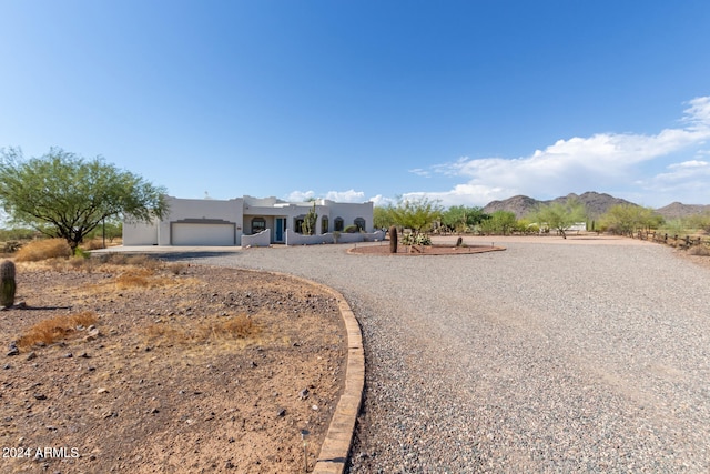 southwest-style home featuring a mountain view and a garage