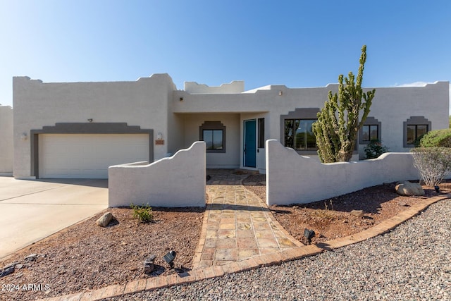 36382 N 35th St, Cave Creek, AZ 85331 - pueblo revival-style home featuring an attached garage, concrete driveway, and stucco siding