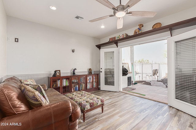 living room with ceiling fan and light hardwood / wood-style flooring