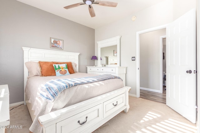 bedroom with light carpet and ceiling fan