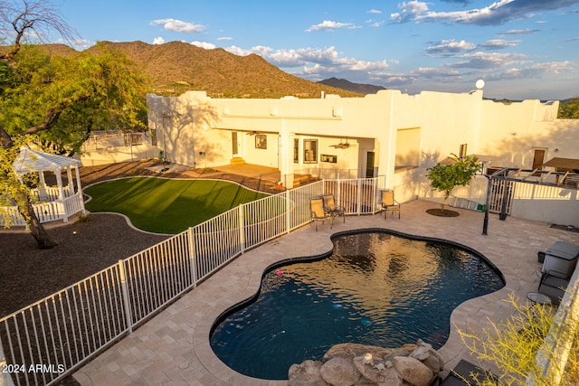 view of swimming pool with a patio area and a mountain view