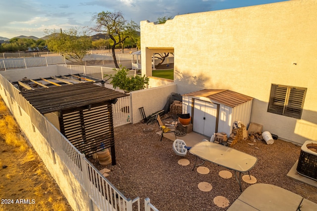 exterior space with a mountain view and a storage shed