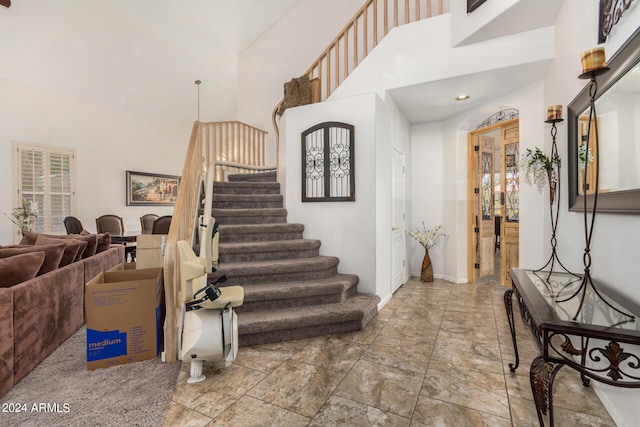 foyer featuring a towering ceiling