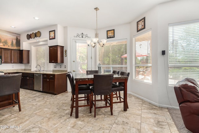 dining space featuring an inviting chandelier and sink