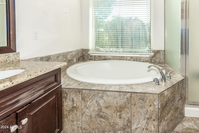 bathroom featuring vanity and plus walk in shower