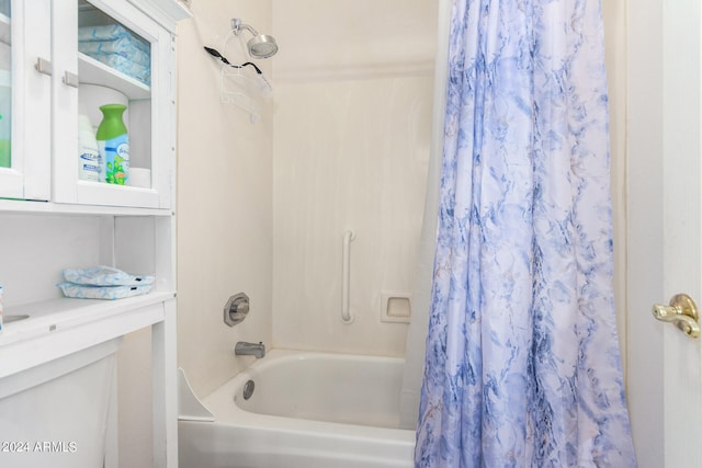 bathroom with shower / bath combination with curtain