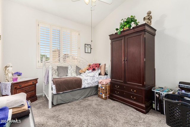 bedroom featuring light colored carpet, vaulted ceiling, and ceiling fan