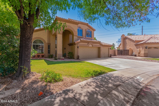 mediterranean / spanish home featuring a front yard