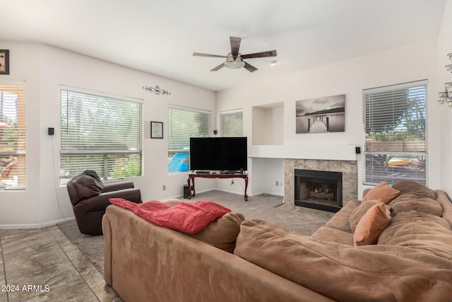 living room with a fireplace and ceiling fan