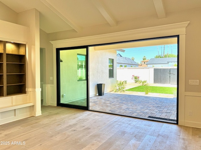 3021 N 47th St, Phoenix, AZ 85018 - doorway with beam ceiling, wood finished floors, built in shelves, and a wainscoted wall