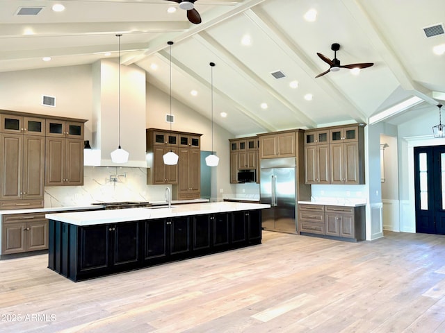 3021 N 47th St, Phoenix, AZ 85018 - kitchen featuring stainless steel appliances, ceiling fan, a large island, light countertops, and light wood-type flooring