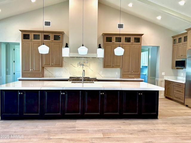 3021 N 47th St, Phoenix, AZ 85018 - kitchen with a large island, backsplash, light wood-style floors, high vaulted ceiling, and light stone counters