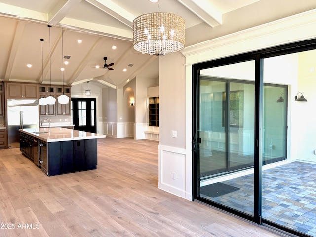 3021 N 47th St, Phoenix, AZ 85018 - kitchen featuring a decorative wall, light countertops, light wood finished floors, a spacious island, and a chandelier
