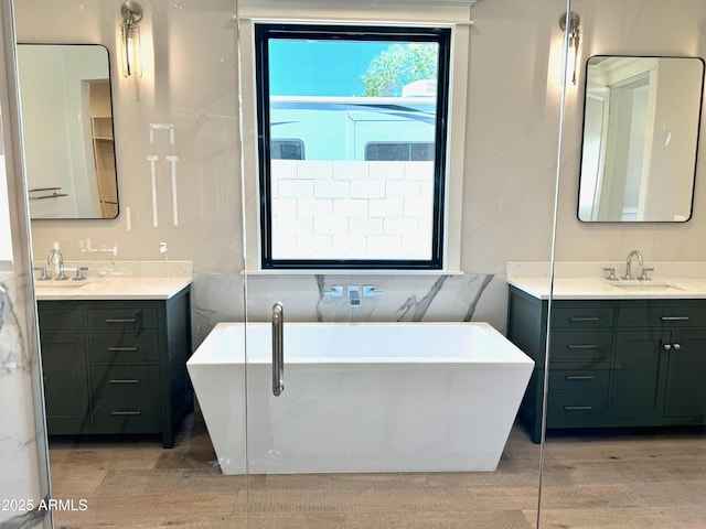 3021 N 47th St, Phoenix, AZ 85018 - bathroom with two vanities, wood finished floors, and a freestanding tub