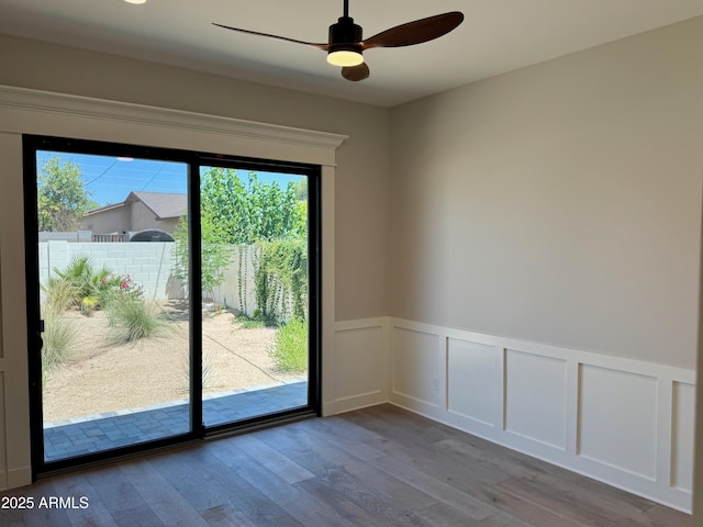 3021 N 47th St, Phoenix, AZ 85018 - unfurnished room featuring healthy amount of natural light, wainscoting, wood finished floors, ceiling fan, and a decorative wall