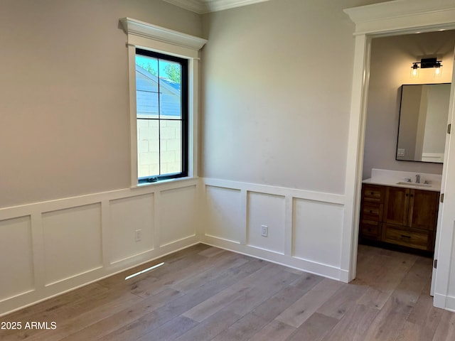 3021 N 47th St, Phoenix, AZ 85018 - unfurnished room with a decorative wall, light wood-type flooring, ornamental molding, and a wainscoted wall