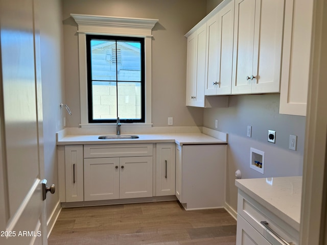 3021 N 47th St, Phoenix, AZ 85018 - laundry room featuring electric dryer hookup, hookup for a washing machine, cabinet space, and light wood-style floors