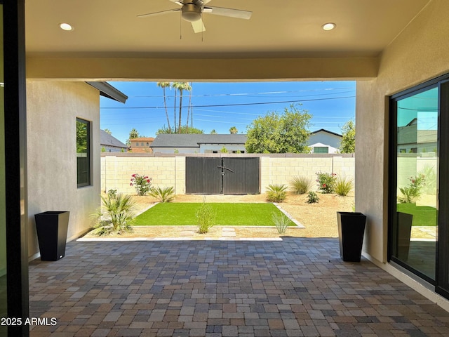 3021 N 47th St, Phoenix, AZ 85018 - fenced backyard featuring a ceiling fan and a patio
