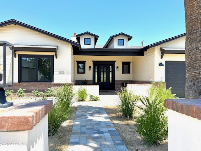 3021 N 47th St, Phoenix, AZ 85018 - view of front of property with brick siding, french doors, and covered porch