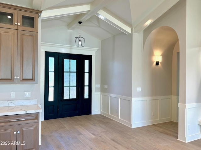 3021 N 47th St, Phoenix, AZ 85018 - foyer with wainscoting, light wood finished floors, arched walkways, and a decorative wall