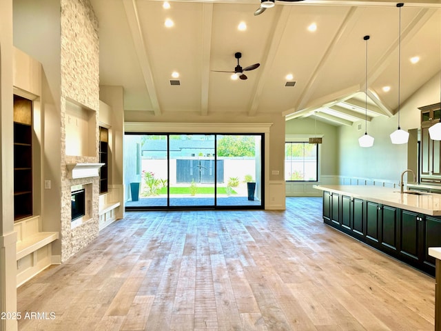 3021 N 47th St, Phoenix, AZ 85018 - unfurnished living room with ceiling fan, light wood finished floors, built in shelves, beam ceiling, and recessed lighting