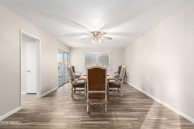 dining area featuring baseboards, wood finished floors, and a ceiling fan