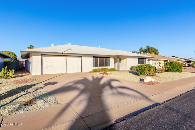 single story home featuring concrete driveway, an attached garage, and fence