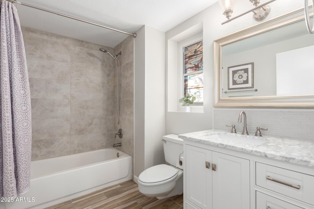 full bathroom featuring shower / bathtub combination with curtain, vanity, tasteful backsplash, wood-type flooring, and toilet