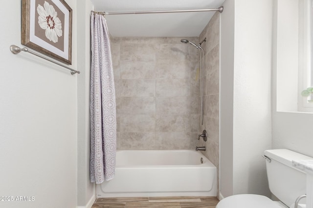 bathroom featuring shower / bathtub combination with curtain, hardwood / wood-style floors, and toilet