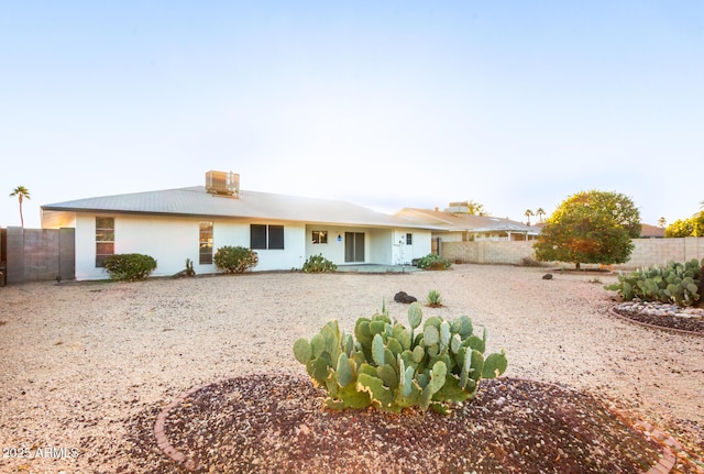 view of front of house featuring fence and stucco siding