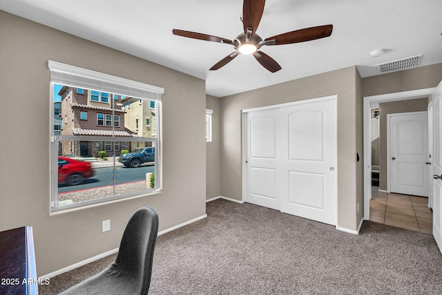 2049 N 77th Dr, Phoenix, AZ 85035 - unfurnished office with visible vents, a ceiling fan, baseboards, and carpet flooring