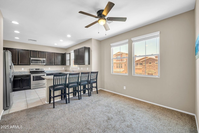 2049 N 77th Dr, Phoenix, AZ 85035 - kitchen featuring stainless steel appliances, light colored carpet, visible vents, and recessed lighting