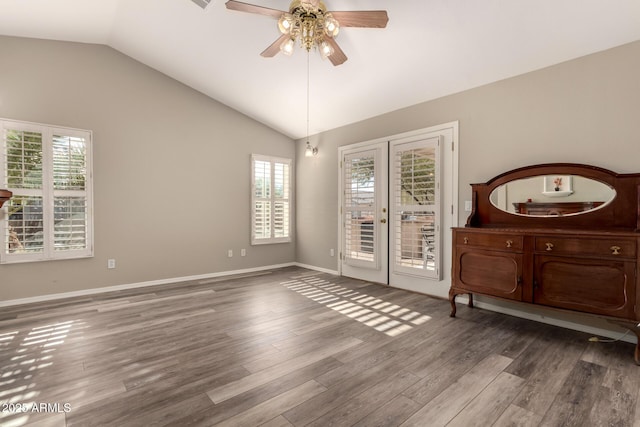 spare room featuring hardwood / wood-style floors, plenty of natural light, ceiling fan, and vaulted ceiling