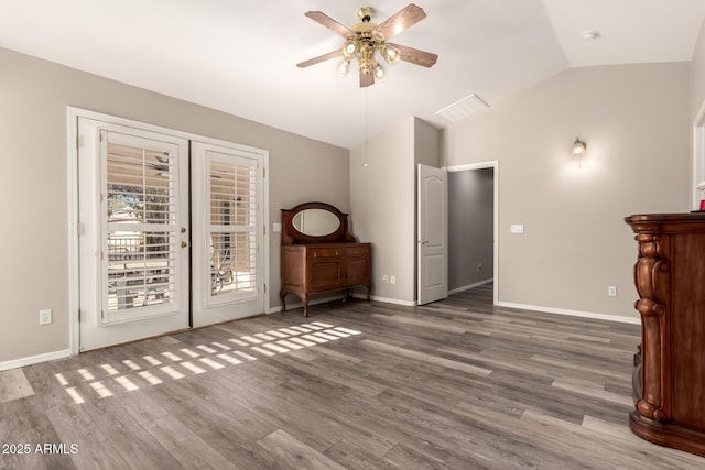 unfurnished living room with hardwood / wood-style flooring, vaulted ceiling, and ceiling fan