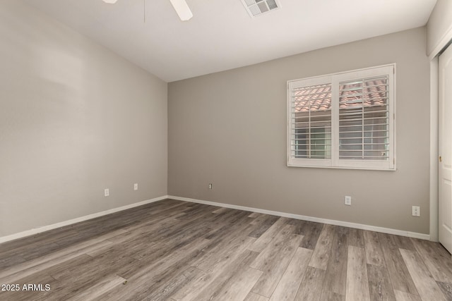 empty room featuring ceiling fan and light hardwood / wood-style flooring