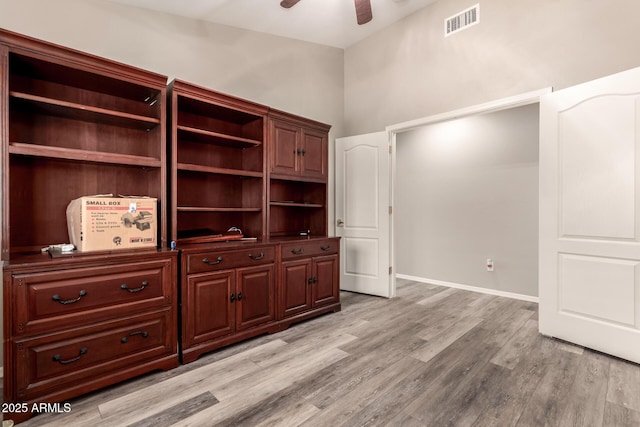 interior space with ceiling fan and light hardwood / wood-style floors