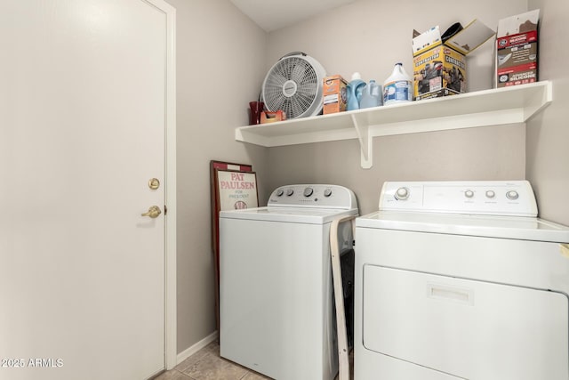 washroom with light tile patterned floors and washing machine and clothes dryer