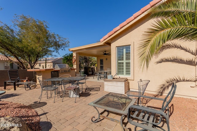 view of patio with ceiling fan and an outdoor kitchen