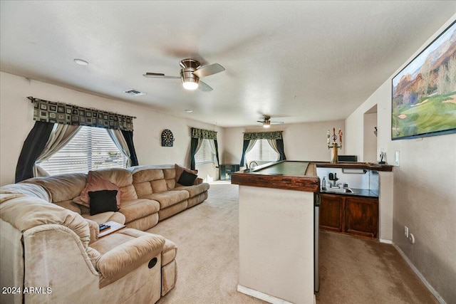 living room with light carpet and ceiling fan