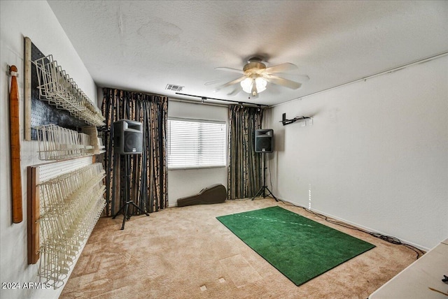 interior space featuring ceiling fan and a textured ceiling