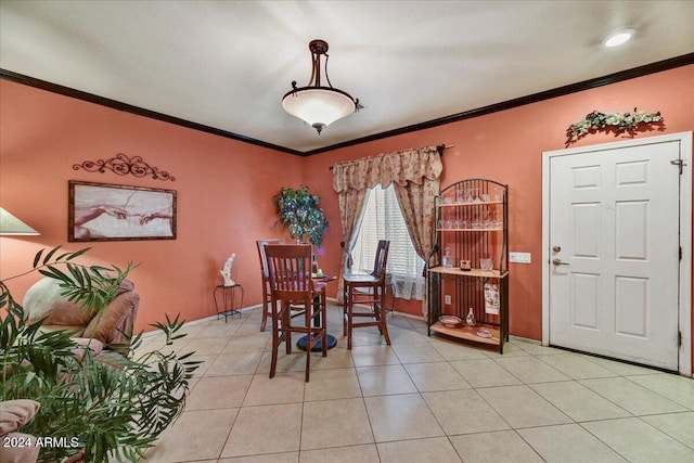 dining room featuring ornamental molding and light tile patterned floors