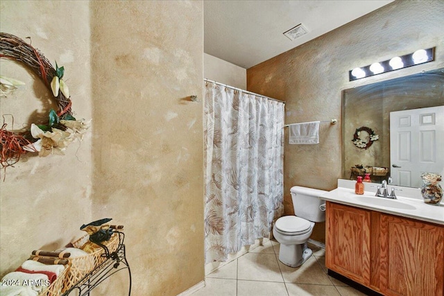 bathroom featuring toilet, vanity, and tile patterned floors