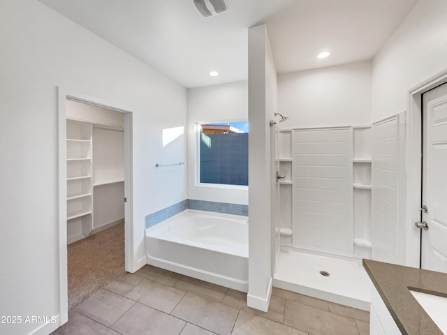 bathroom with tile patterned flooring, vanity, and shower with separate bathtub