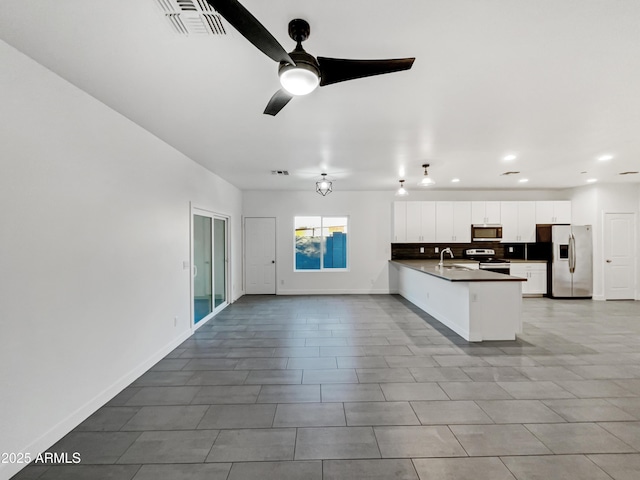 kitchen with backsplash, stainless steel appliances, ceiling fan, sink, and white cabinets