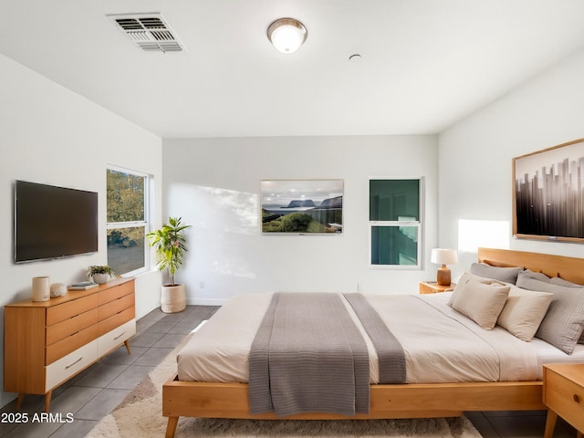 bedroom with light tile patterned floors