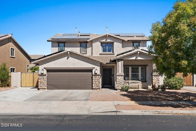 view of front facade with a garage and solar panels