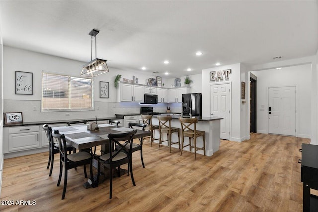 dining area featuring light wood-type flooring